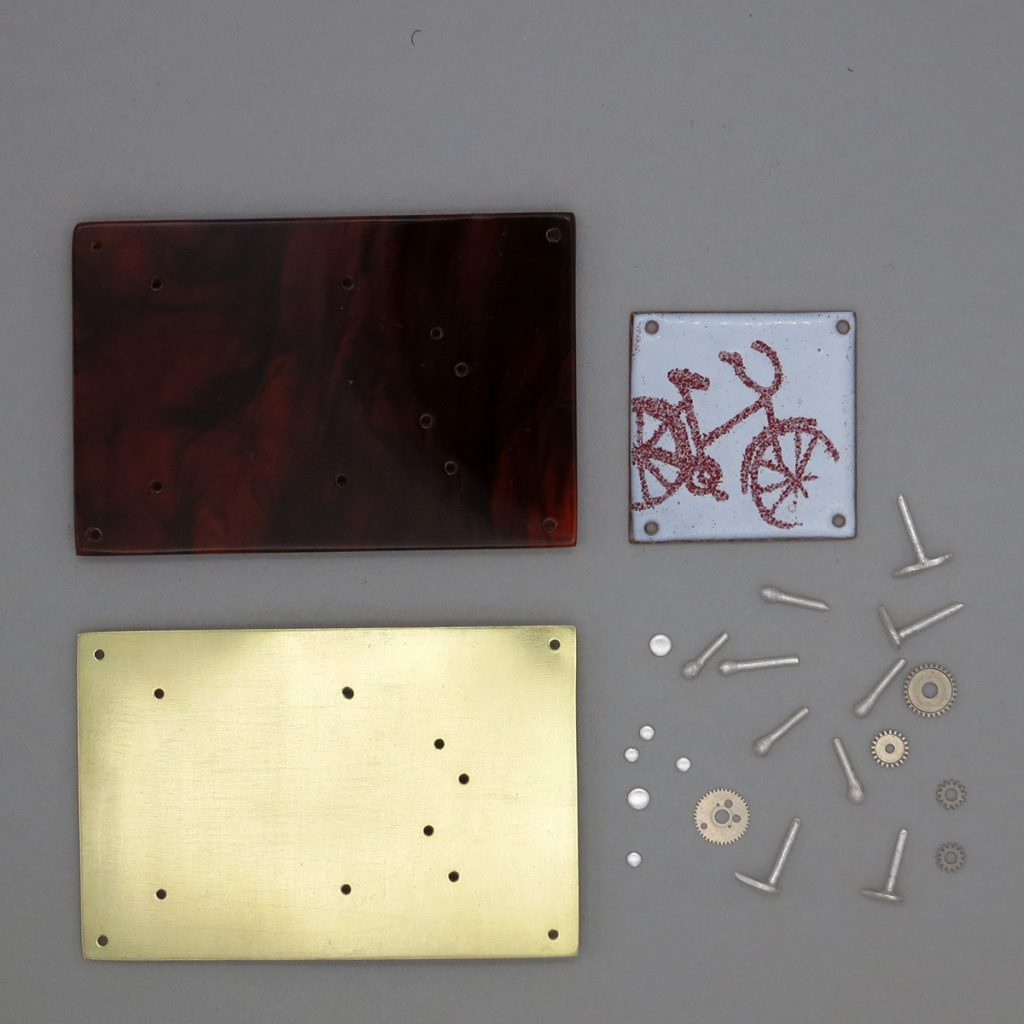 Perspex, enamelled copper, brass and silver components for a brooch